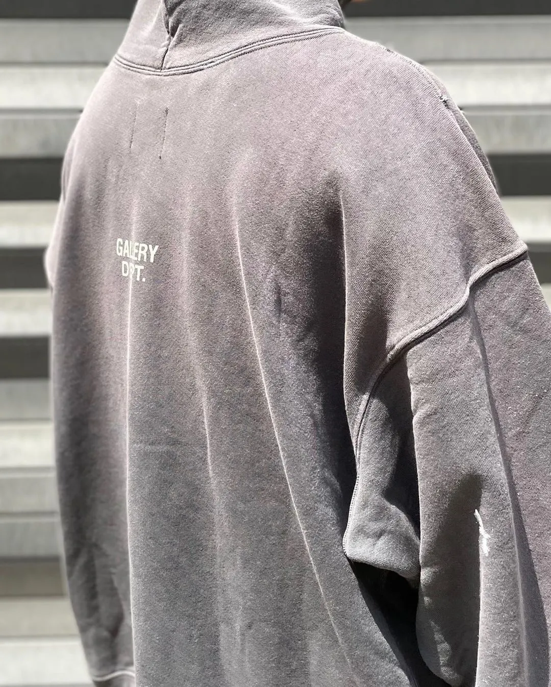 GALLERY DEPT. 90'S RECYCLE HOODIE WASHED BLACK 90'S washed hoodie with distressed eco-friendly slogans. Washed black S-XL. Ready-made garments are washed and dyed again. Multiple spots throughout the body are spray-faded. The ribs are cut and worn.